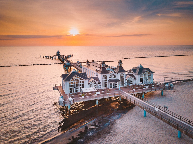 Aerial view of famous Sellin Seebruecke (Sellin Pier) in beautiful golden morning light at sunrise in summer, Ostseebad Sellin tourist resort, Baltic Sea region, Germany